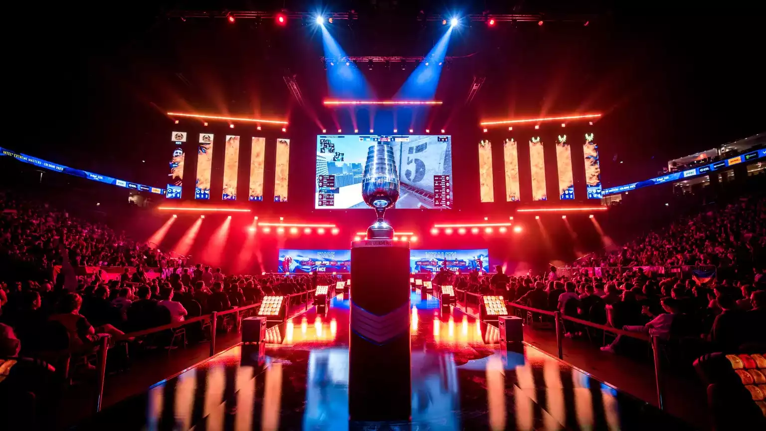 A crowd seated at the arena next to a light up stage for the 2023 IEM Cologne tournament