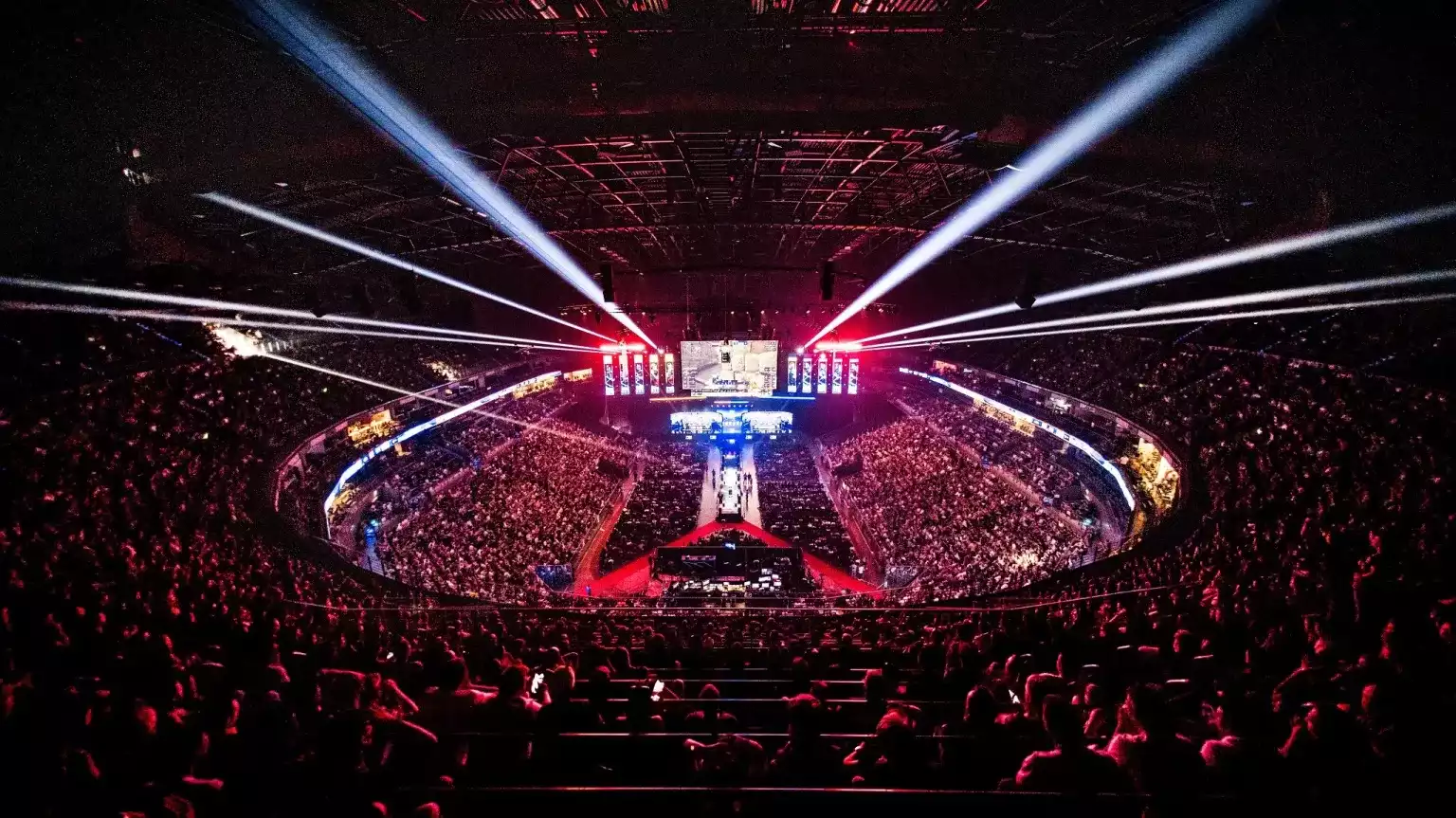 A crowd seated at the arena next to a light up stage for the IEM Cologne tournament