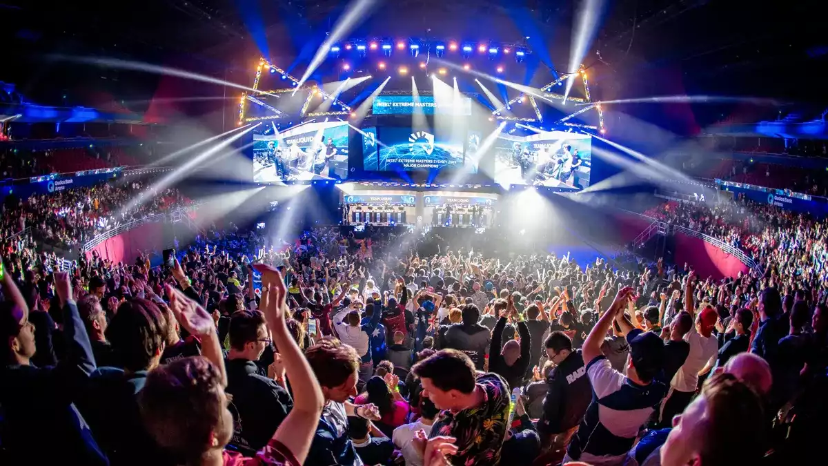 A crowd seated at the arena next to a light up stage for the IEM sydney tournament