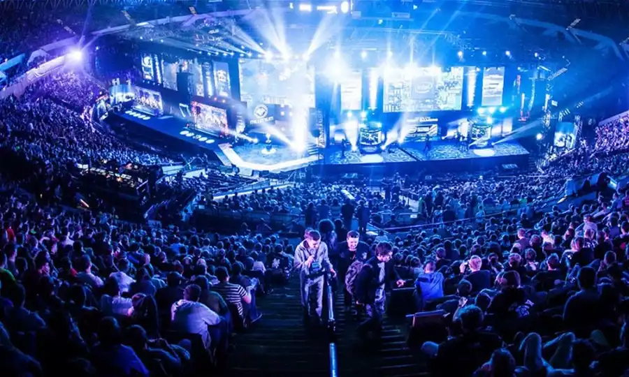 Crows seated at a blue light up stage to watch the latest CSGO major